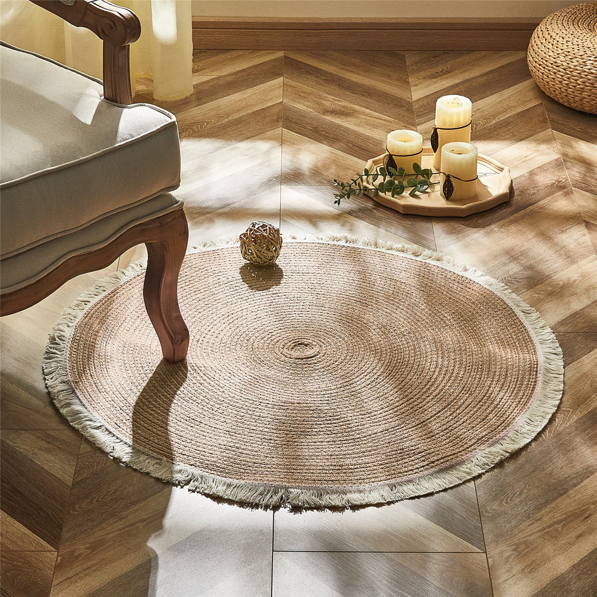 Round two tone braided rug with a cream fringe on a herringbone floor