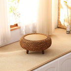 Low round coffee table hand woven in brown wicker on rattan legs