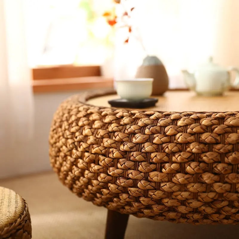 Low round coffee table hand woven in brown wicker on rattan legs