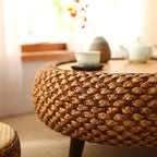Low round coffee table hand woven in brown wicker on rattan legs