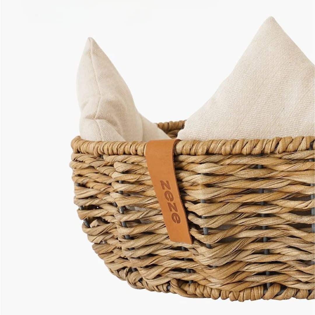 Round wicker dog basket with a cream cushion