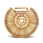 Round handbag pairing smooth sanded wood with a hand woven rattan body