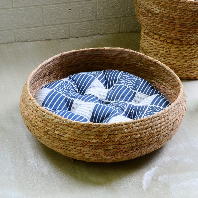 Large round low woven basket with a blue striped cushion