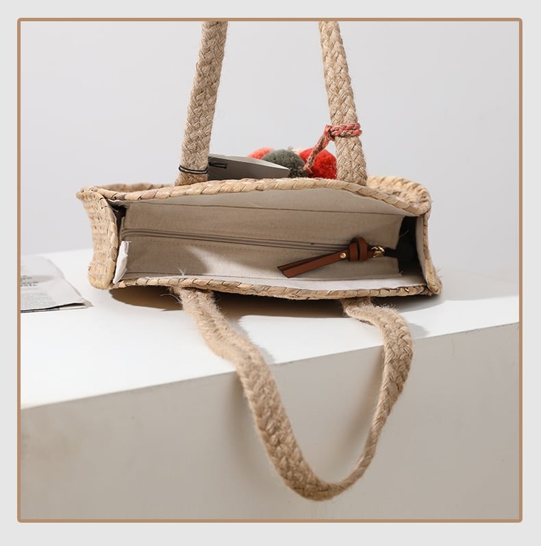Round hand woven crossbody bag with a textured weave and hand knotted pompoms