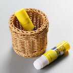 Small round woven cup holding tubes and toiletries
