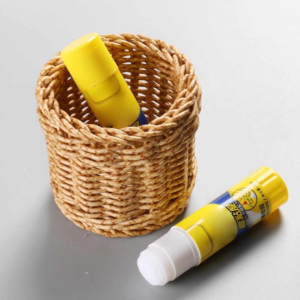 Small round woven cup holding tubes and toiletries