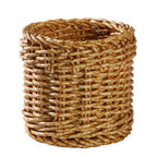 Small round woven cup holding tubes and toiletries