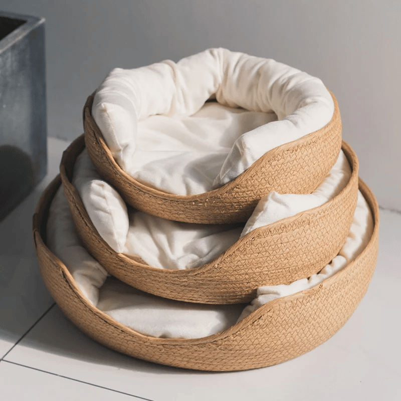 Round woven pet bed with plush removable cushions