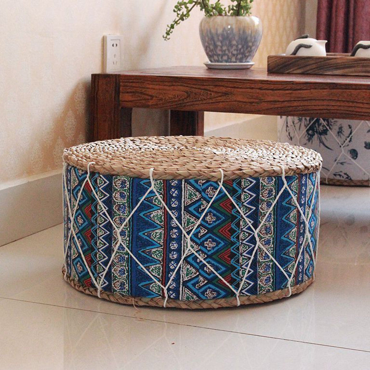 Round hand woven rattan pouf with blue tone patterns