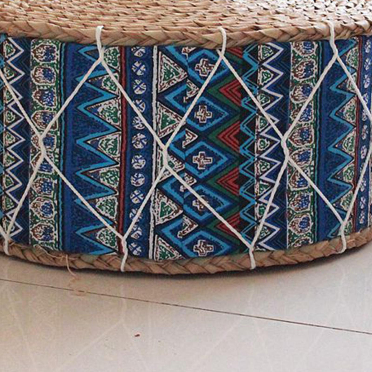 Round hand woven rattan pouf with blue tone patterns