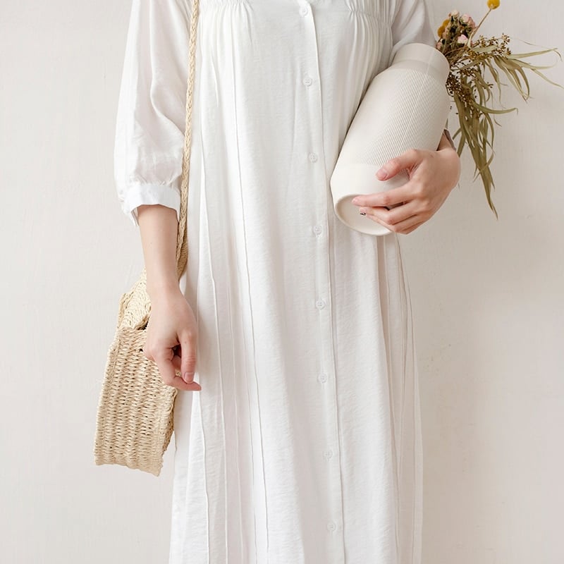 Round hand woven rattan crossbody bag with an adjustable strap in brown or beige