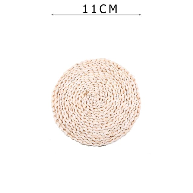 Round hand woven rattan coaster under a white coffee cup