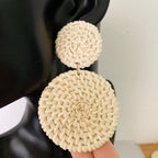 Pair of drop earrings made of two stacked round woven rattan discs