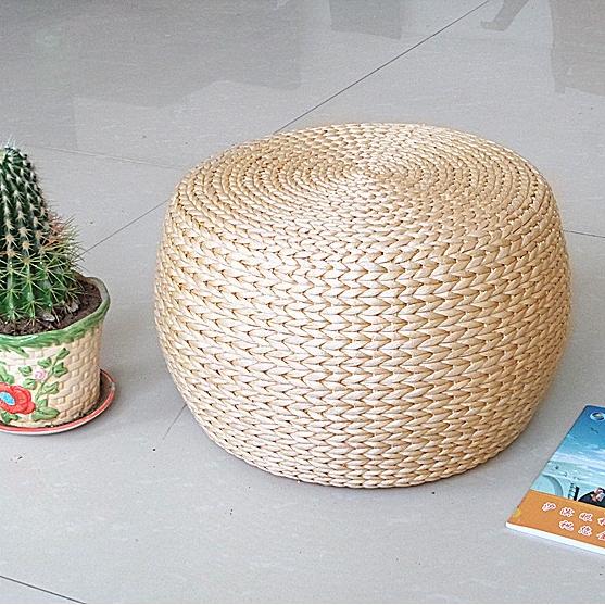 Round domed footstool hand woven in rattan with a chevron pattern