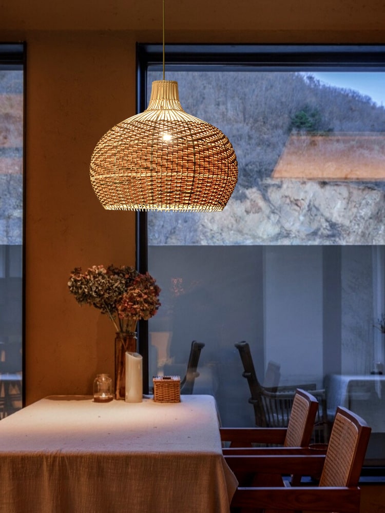 Round woven rattan globe pendant above a dining table