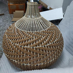 Round woven rattan globe pendant above a dining table
