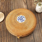 Round hand woven rattan jewelry box with a geometric pattern and lid