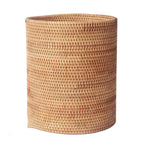 Round straight sided woven rattan bucket holding white flowers