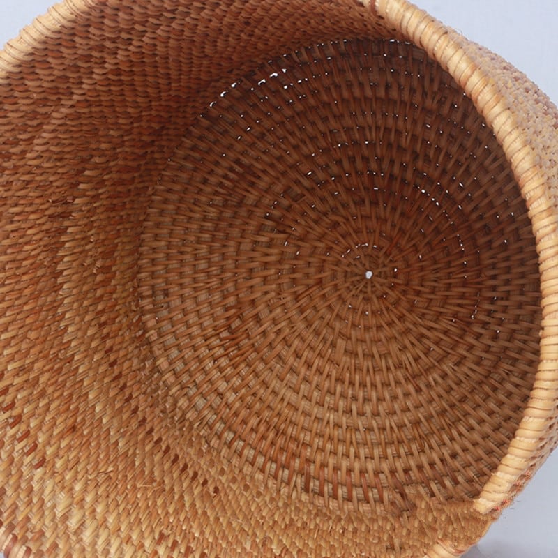 Round straight sided woven rattan bucket holding white flowers