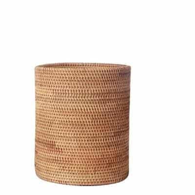 Round straight sided woven rattan bucket holding white flowers