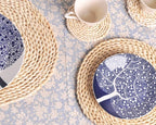 Round hand woven rattan trivets in three sizes on a table