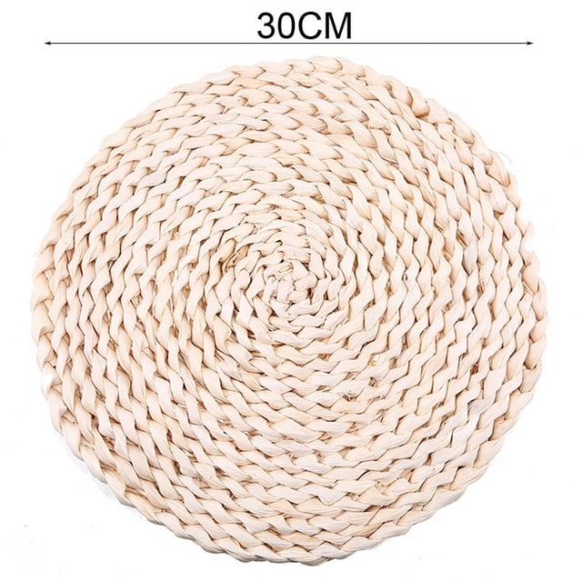 Round hand woven rattan trivets in three sizes on a table