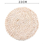 Round hand woven rattan trivets in three sizes on a table