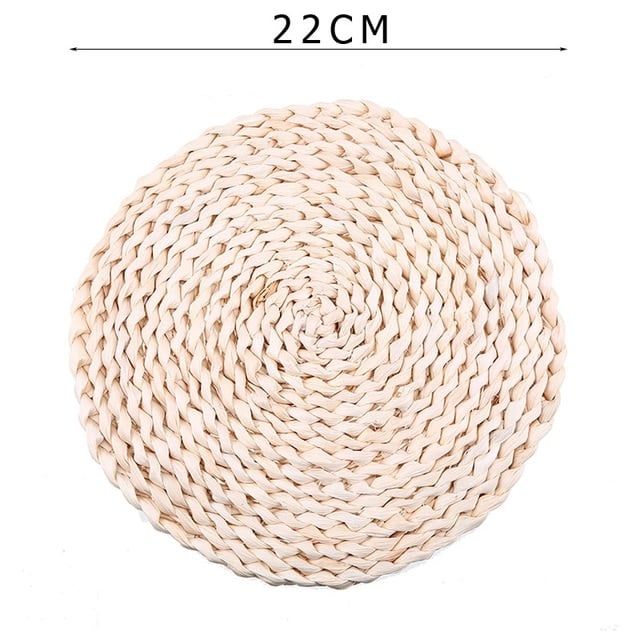 Round hand woven rattan trivets in three sizes on a table