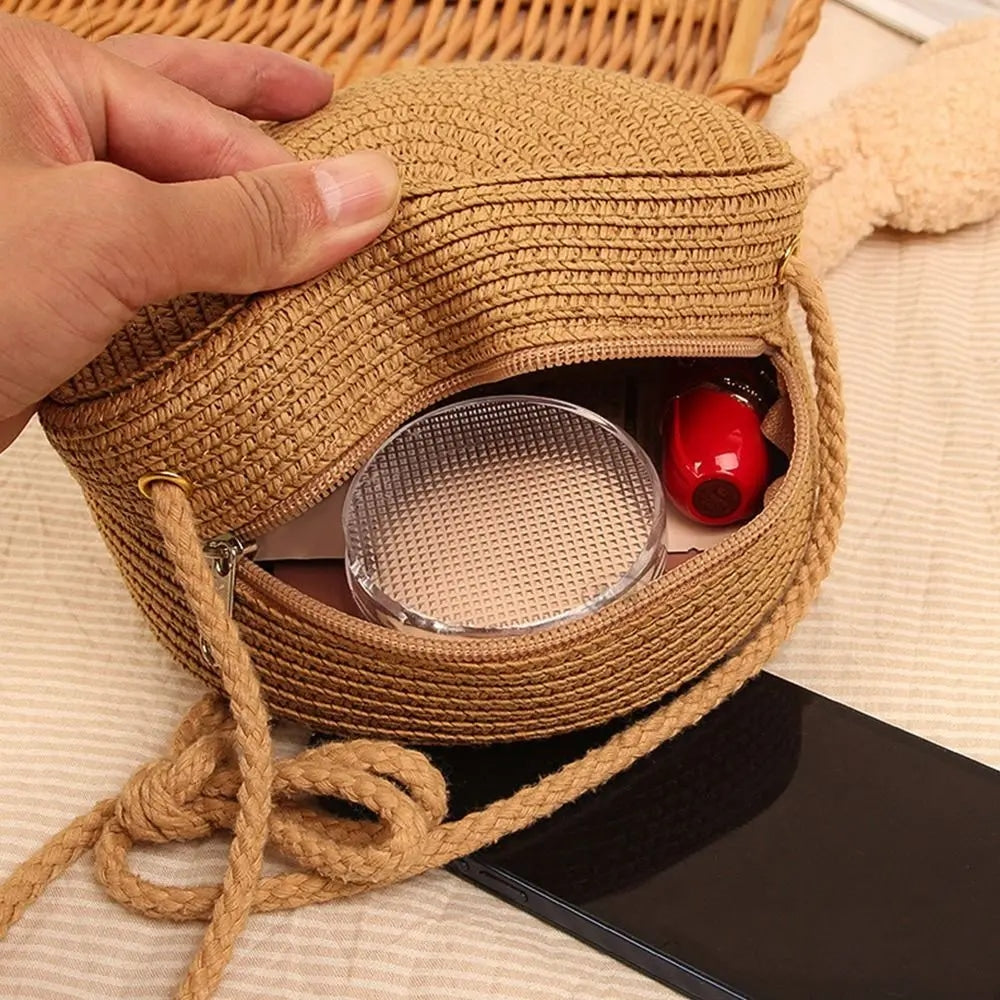 Round brown woven straw crossbody bag worn on the shoulder