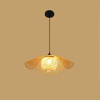 Ruffled flower shaped rattan pendant glowing warm