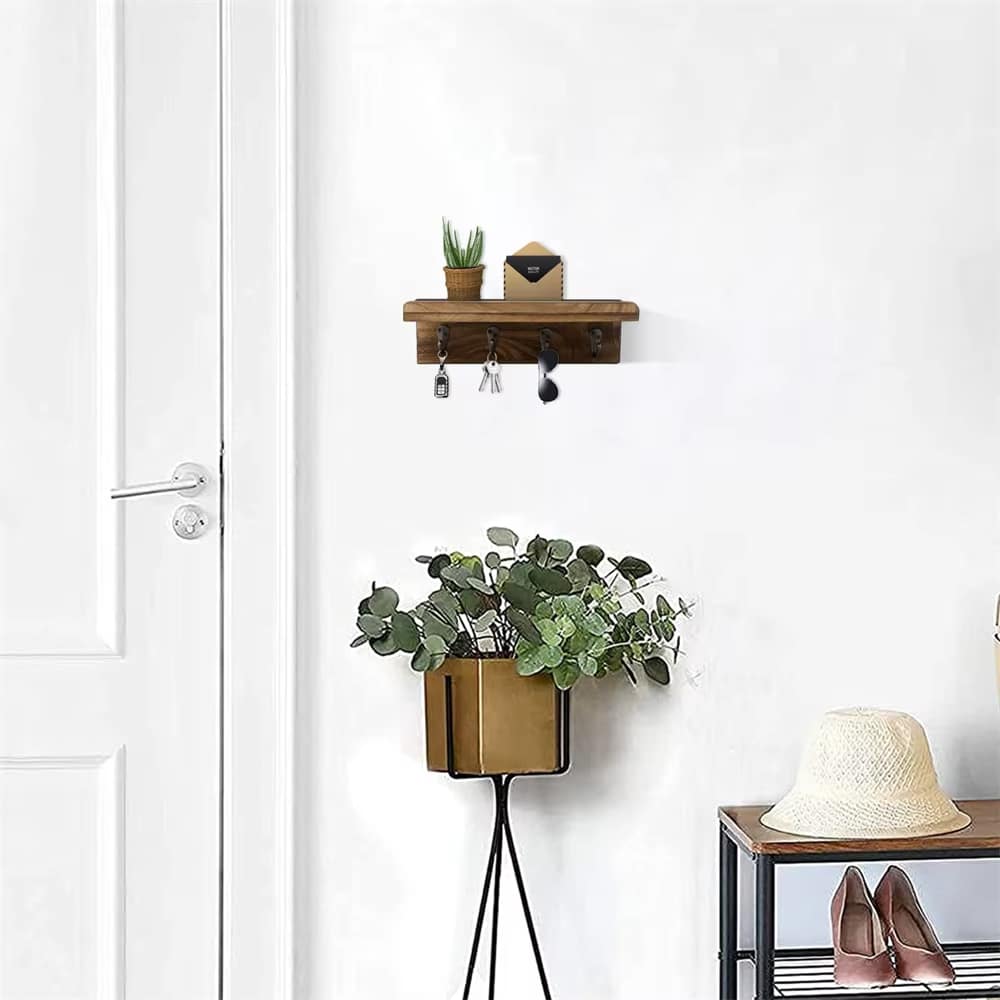 Rustic wood key holder shelf with four hooks holding keys and mail