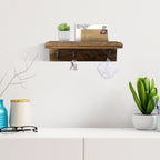 Rustic wood key holder shelf with four hooks holding keys and mail