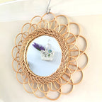 Scalloped rattan petals around a woven ring.