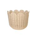 Beige handwoven rattan basket with a scalloped edge