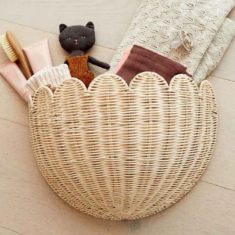 Half moon scalloped rattan wall basket holding plush toys