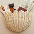 Half moon scalloped rattan wall basket holding plush toys
