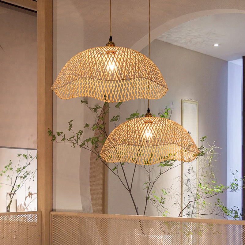 Two scalloped woven bamboo dome pendants at different heights