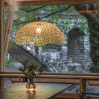 Two scalloped woven bamboo dome pendants at different heights