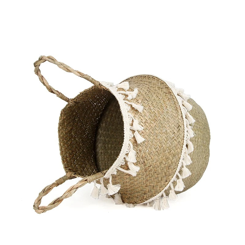 Woven belly basket with two rows of white tassels and handles
