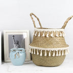 Woven belly basket with two rows of white tassels and handles