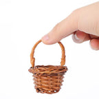 Tiny handwoven basket with handle held between fingers