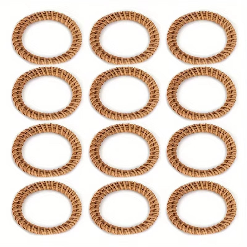 Set of twelve hand woven rattan napkin rings in a warm honey tone