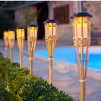 Set of twelve woven rattan solar garden lights on stakes