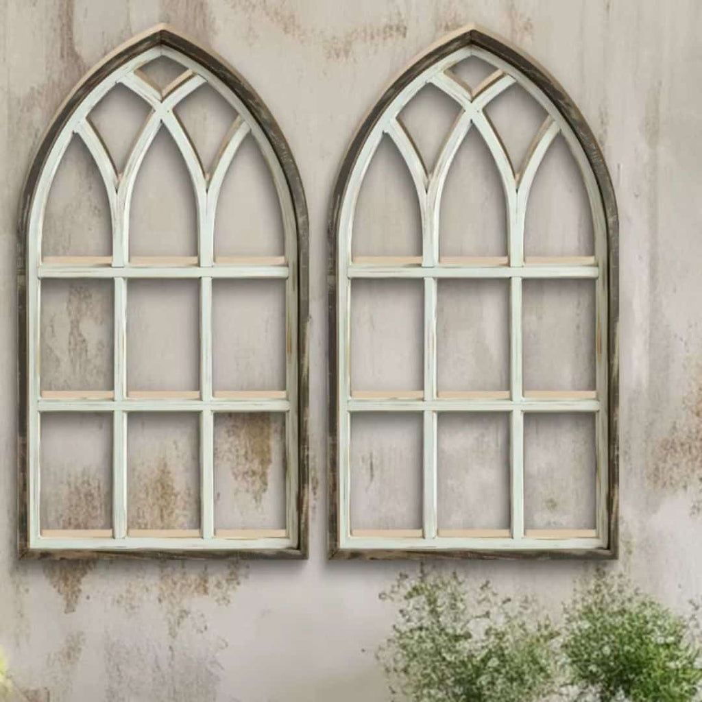 Two arched cathedral style window frames in distressed wood