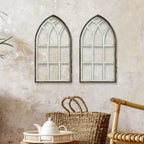 Two arched cathedral style window frames in distressed wood