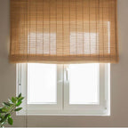 Two matching brown bamboo roll up blinds with cords and top brackets