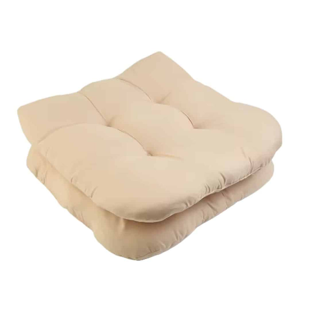 Two thick beige polyester seat cushions with ties for rattan chairs