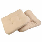 Two thick beige polyester seat cushions with ties for rattan chairs