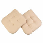 Two thick beige polyester seat cushions with ties for rattan chairs