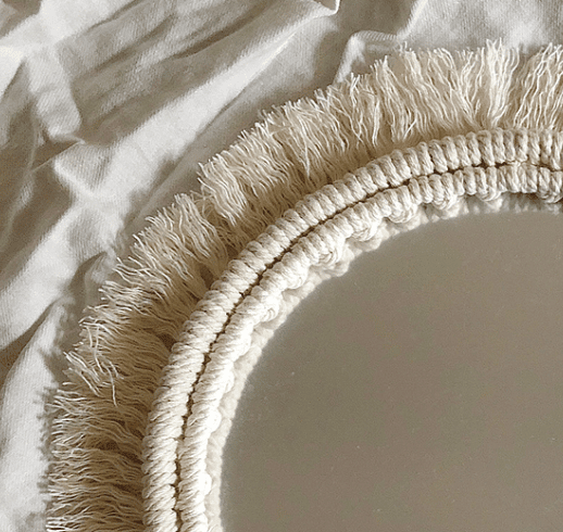 Two round mirrors with white macrame fringe frames